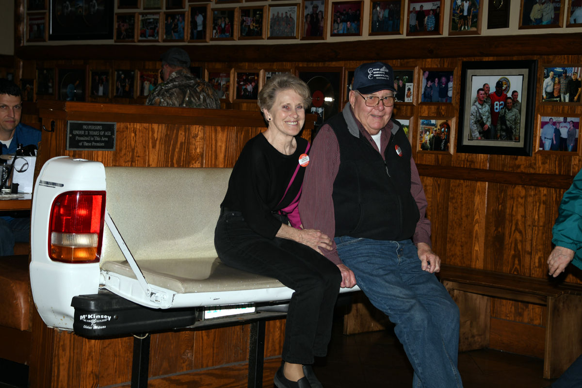 006 Wanda and Doug Peterson on unique tailgate benches at Toby Keith's.JPG